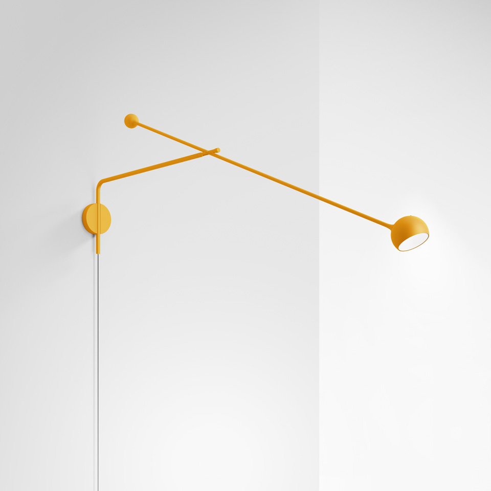 Artemide Ixa wall lamp in yellow, featuring a long adjustable arm with small counterbalance and directional round head