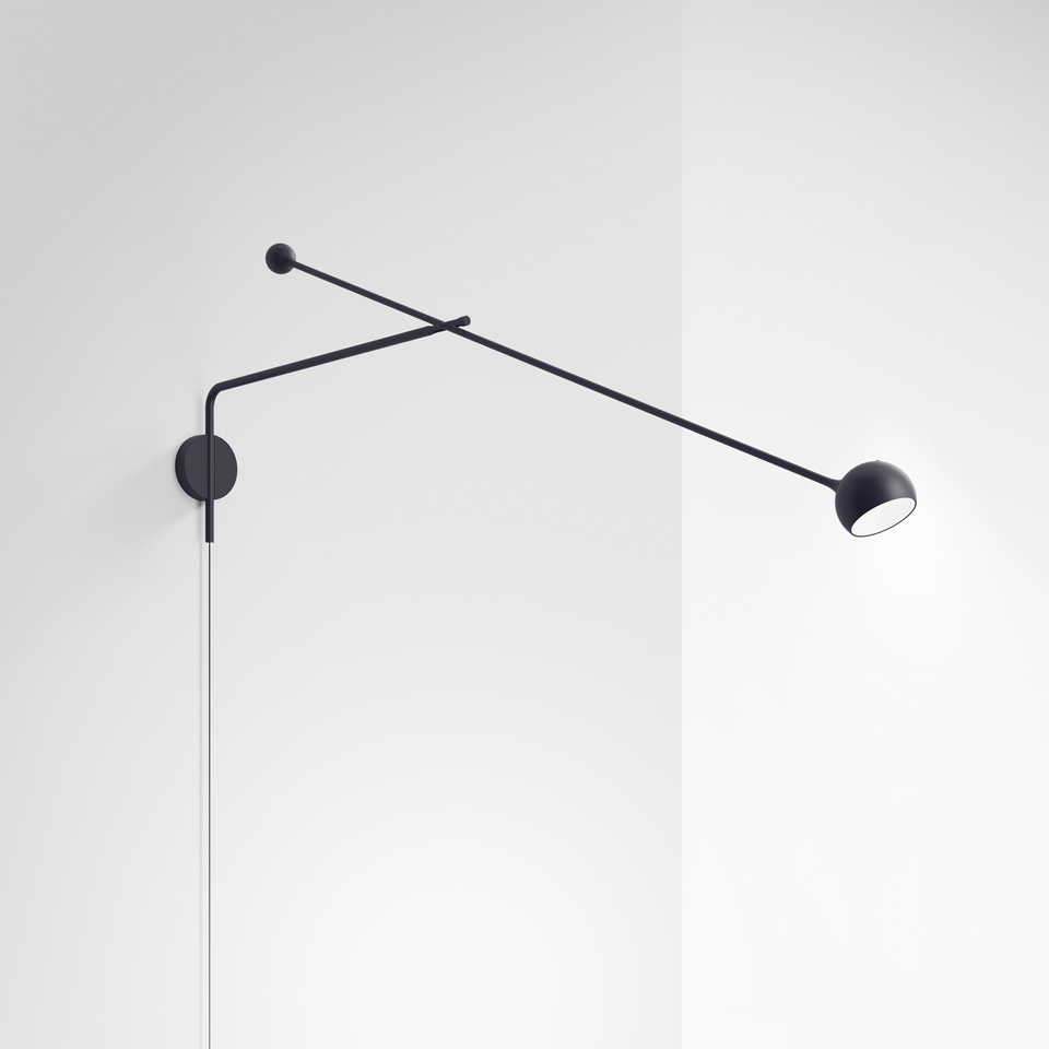 Artemide Ixa wall lamp in black, featuring a long adjustable arm with small counterweight and spherical LED head