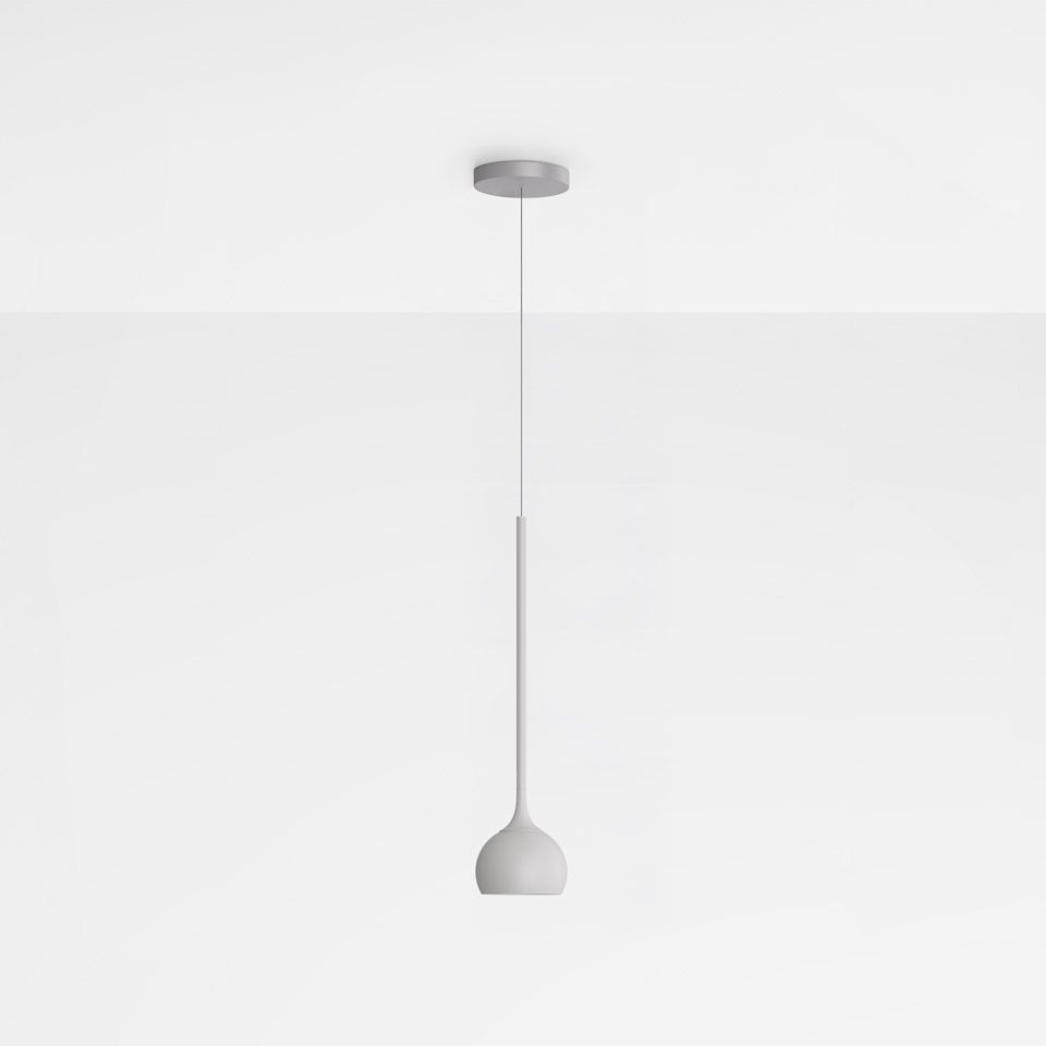 Artemide Ixa pendant lamp in white, featuring a slender stem and rounded bell-shaped diffuser suspended from a ceiling canopy
