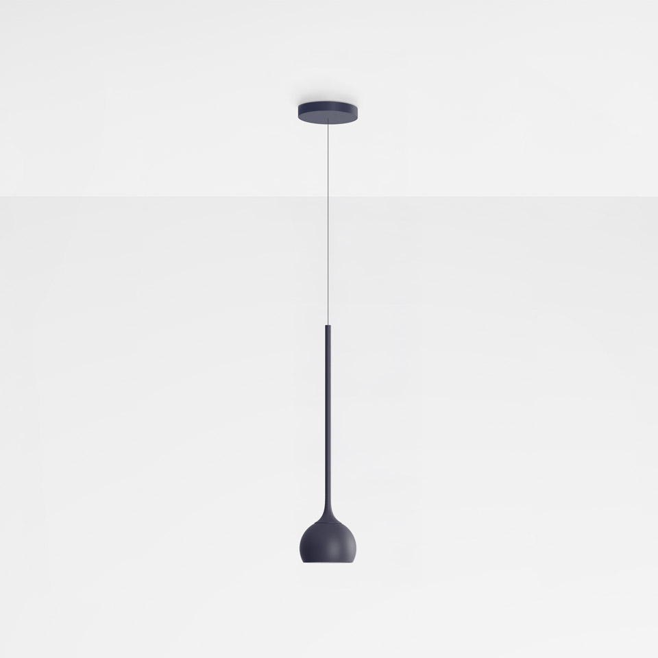 Artemide Ixa pendant lamp in dark blue, featuring a slender stem and rounded bell-shaped shade, suspended from a ceiling canopy