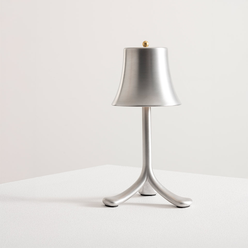 Artemide Trois Rois table lamp: brushed aluminum bell shade on tripod base with gold finial, cordless portable design