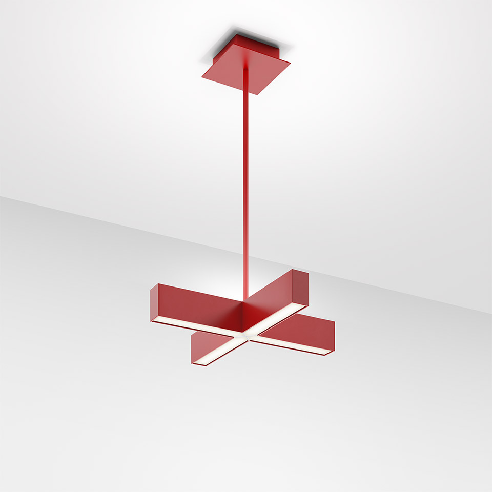 Artemide Tetras pendant lamp in red, cross-shaped LED fixture suspended from ceiling by a slim rod, emitting white light