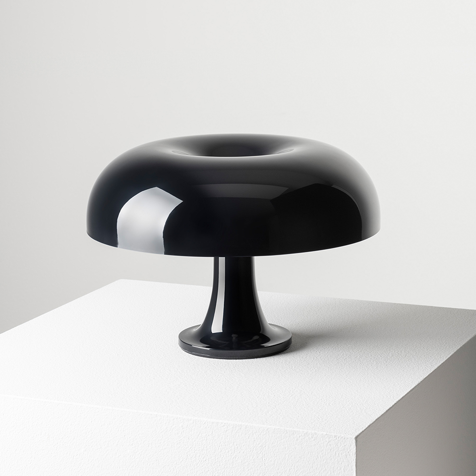 Artemide Nessino table lamp in glossy black, featuring iconic mushroom-shaped shade with toroidal top on a slender pedestal base