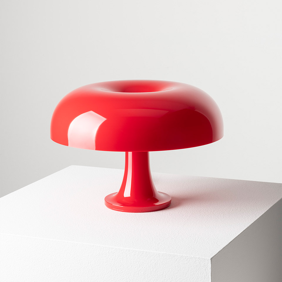 Artemide Nessino table lamp in glossy red, featuring a rounded mushroom-shaped shade and a slender pedestal base