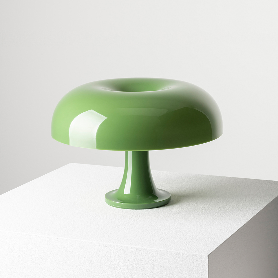 Artemide Nessino table lamp in sage green, featuring a glossy mushroom-shaped shade with toroidal top on a slender pedestal base