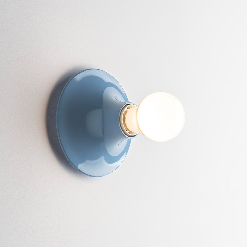 Artemide Teti wall sconce in glossy blue with a round dome backplate and exposed spherical white frosted bulb