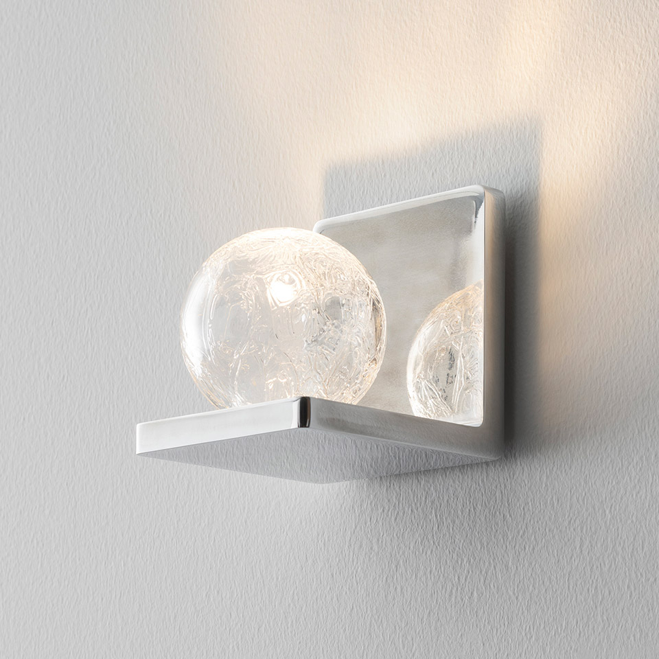 Artemide Ulrich und Diotima wall sconce: chrome square backplate with horizontal arm holding a crackled glass sphere emitting warm light