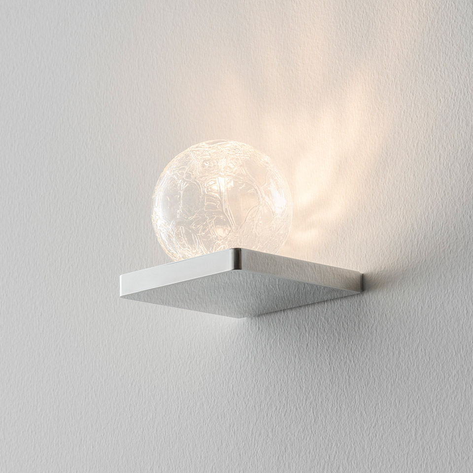Artemide Ulrich und Diotima wall lamp: brushed aluminum square base supporting a textured crystal glass sphere casting decorative light patterns on the wall