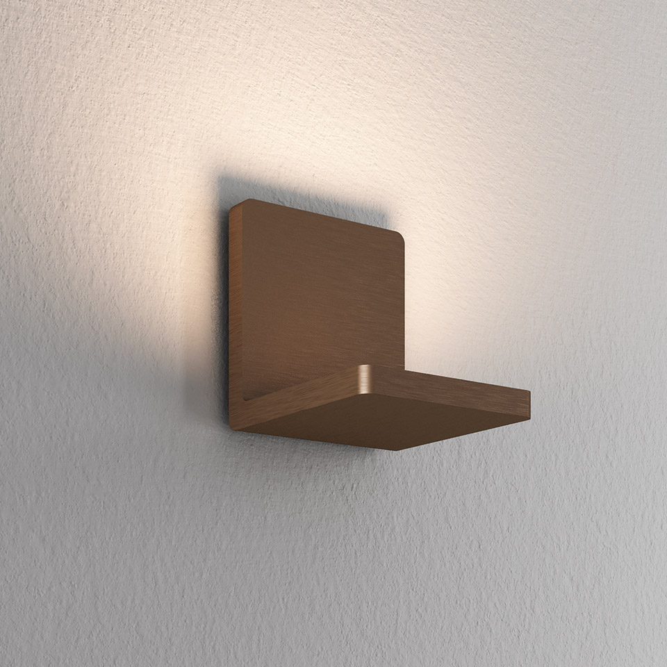 Artemide Ulrich und Diotima wall lamp in brushed bronze finish, square body projecting warm indirect light upward on white wall