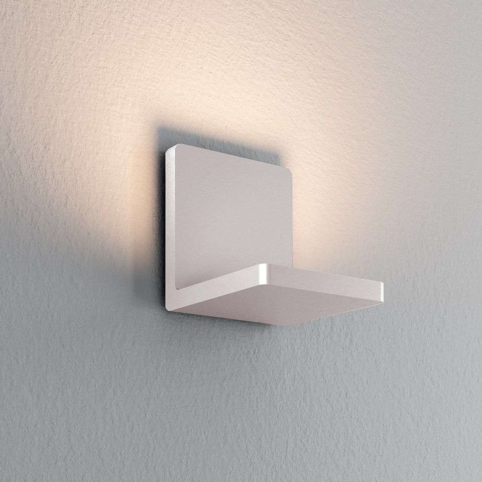 Artemide Ulrich und Diotima white wall sconce with L-shaped body, emitting warm indirect light upward and sideways
