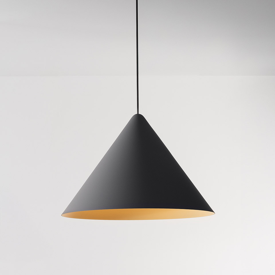 Artemide Vea Suspension pendant lamp with matte black conical shade and warm gold interior, hanging from a black cord