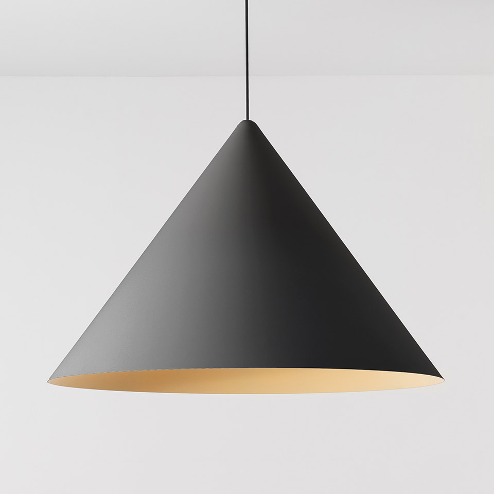 Artemide Vea Suspension pendant lamp with matte black conical shade and warm gold interior, hanging from a black cord
