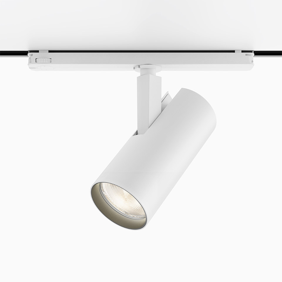 Artemide Vector Track 230V white spotlight mounted on track rail, cylindrical body with LED light source, adjustable orientation