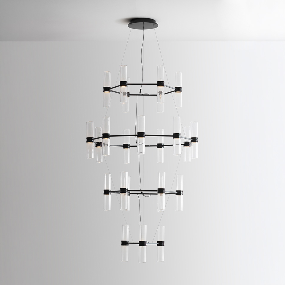 Artemide Zephyr chandelier: three-tier black metal rings with clear cylindrical glass diffusers suspended from ceiling