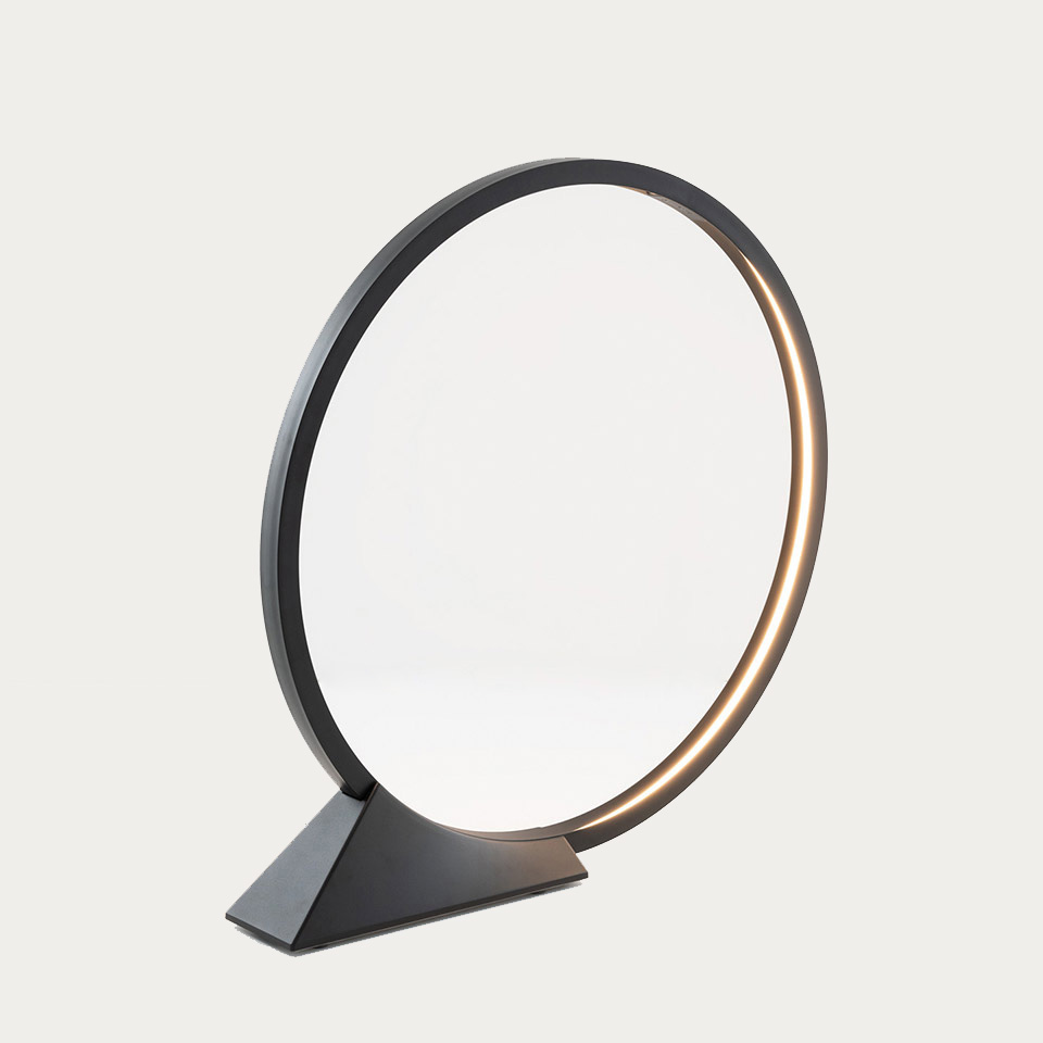 Artemide O table lamp: circular black ring with integrated LED strip on triangular base, emitting warm directional light - 2
