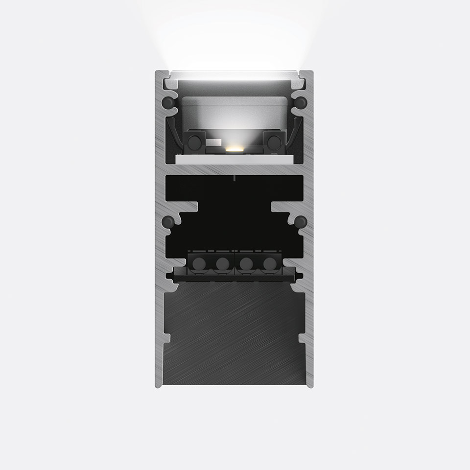 Cross-section of Artemide A.24 Magnetic Track system showing aluminum profile, LED light source emitting upward white light, and magnetic connector components