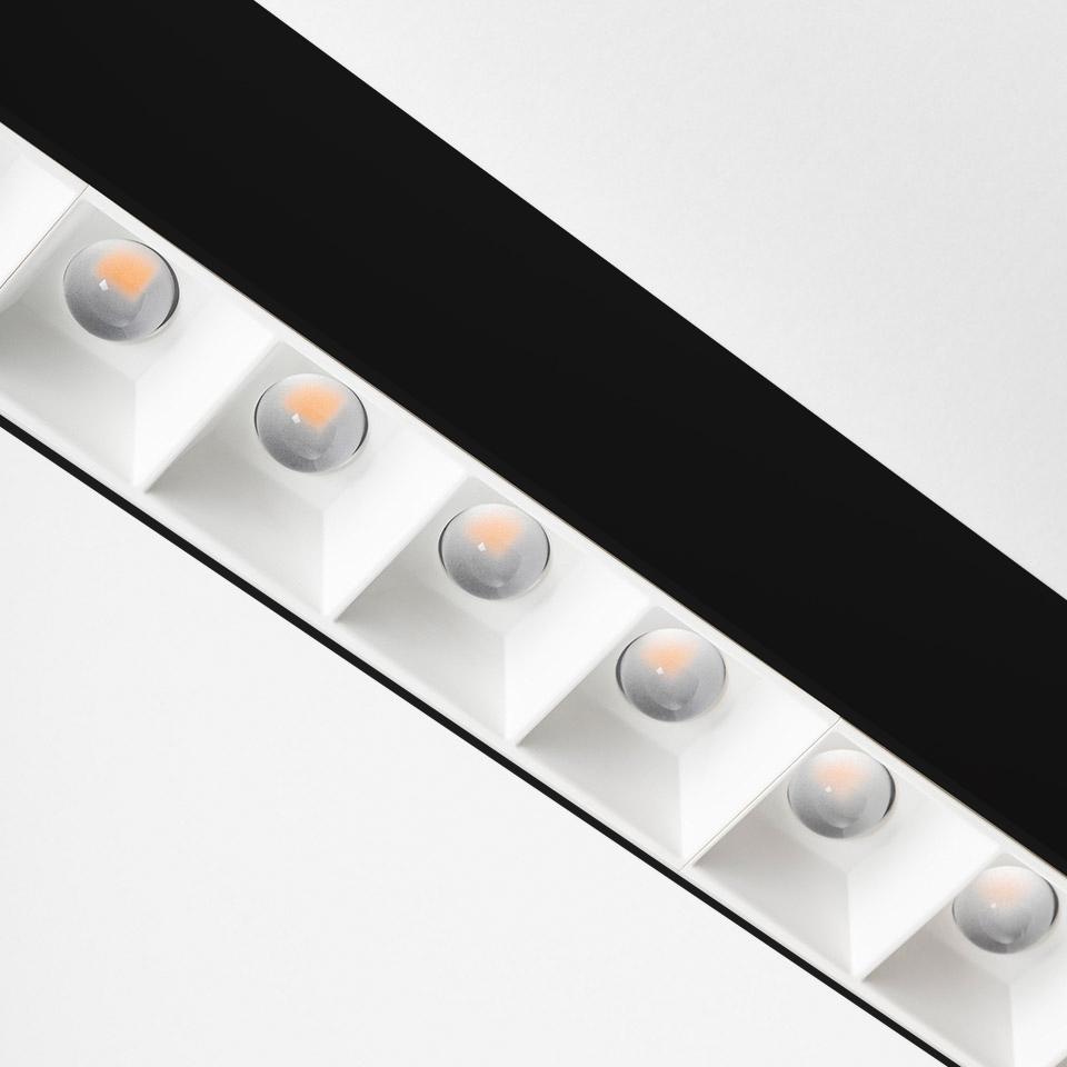 Artemide A.39 ceiling light: diagonal white linear fixture with six square-recessed LED modules featuring refractive lenses on black rail