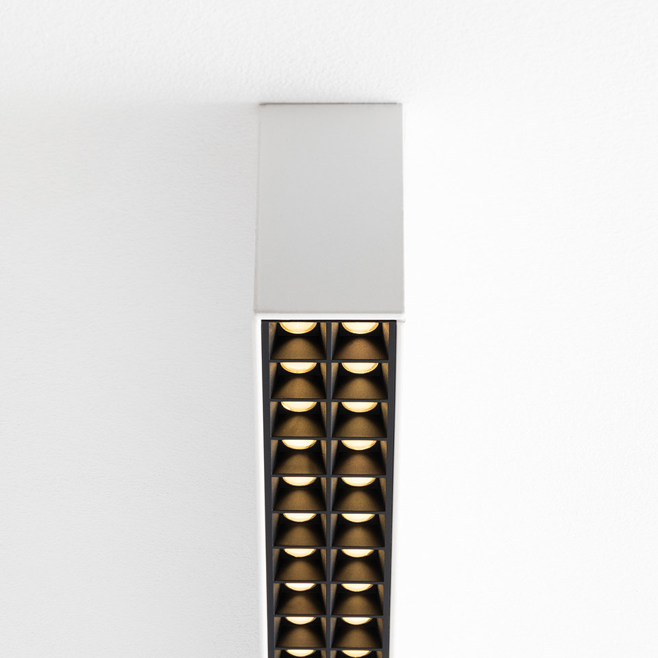Artemide A.39 ceiling suspension lamp with white canopy and elongated dark grid of dual-column LED microrefractive optics