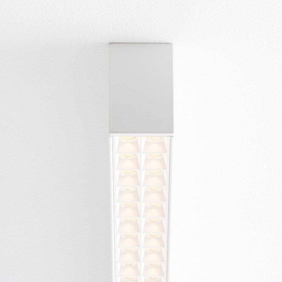 Artemide A.39 ceiling suspension lamp in white, featuring dual rows of microrefractive LED lenses for uniform, glare-controlled illumination