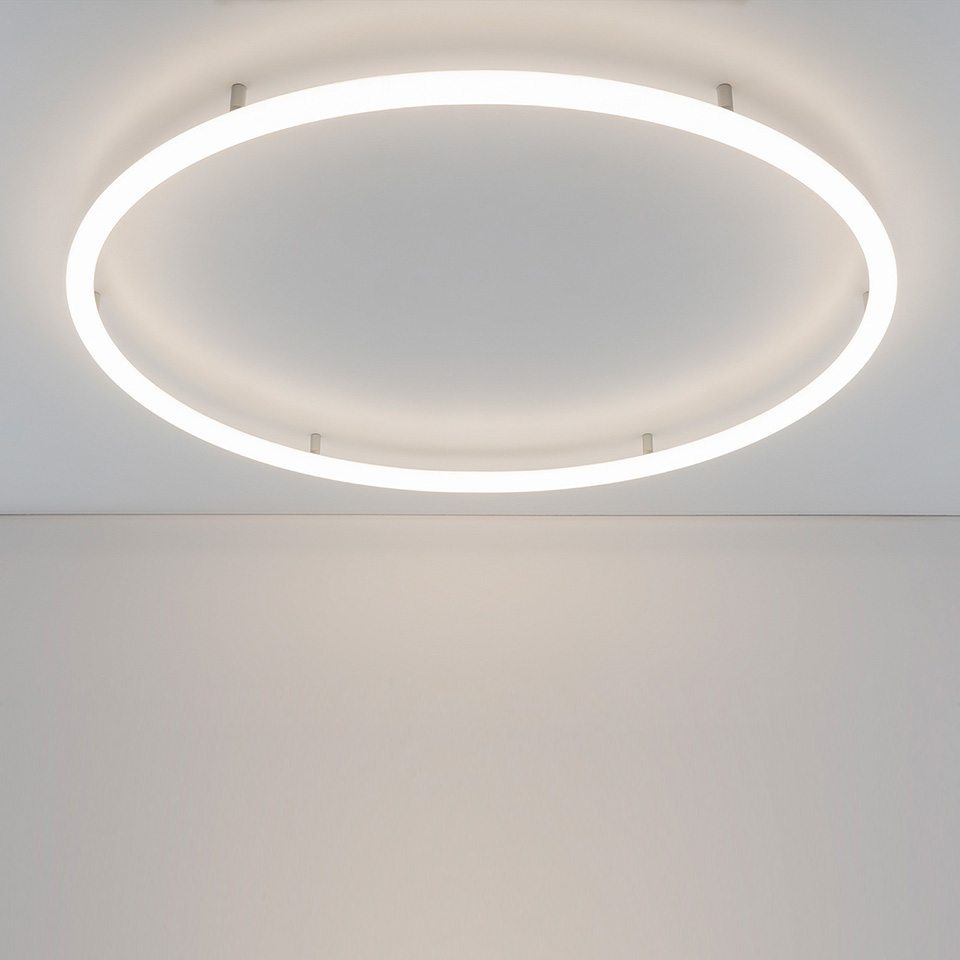 Artemide Alphabet of Light Circular ceiling lamp: large white LED ring mounted flush on white ceiling, emitting soft diffused light
