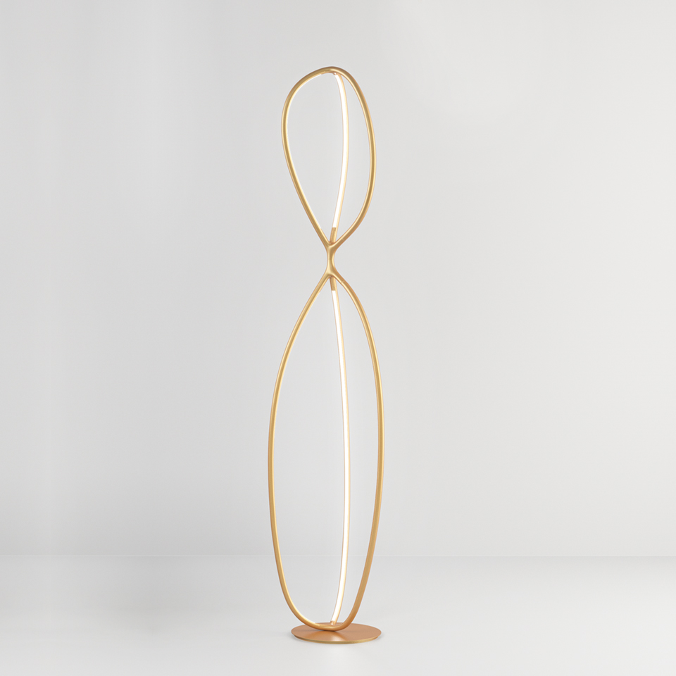 Artemide Arrival floor lamp: gold figure-eight shaped LED tube forming two elongated oval loops on a round base