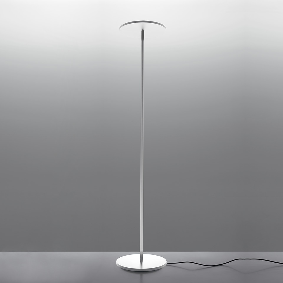 Artemide Athena floor lamp: slim white stem with circular flat disc diffuser on round base, minimalist LED design