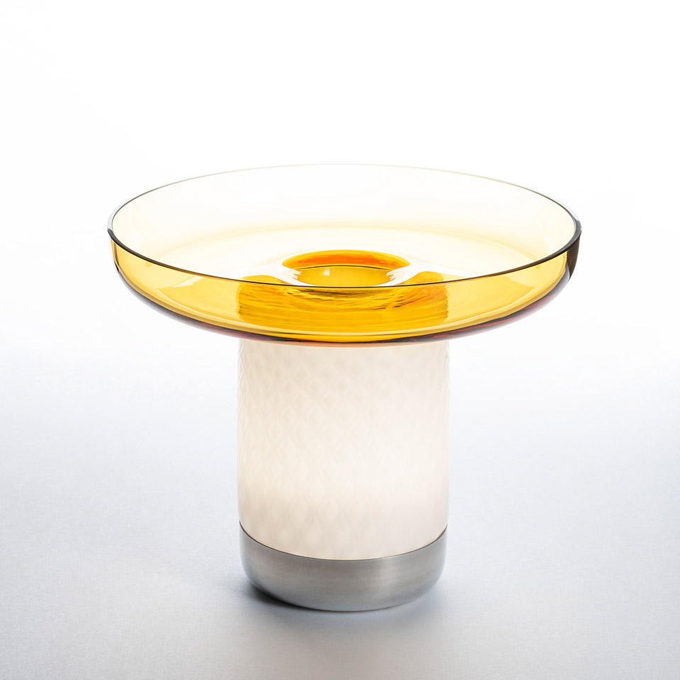 Artemide Bontà table lamp: amber transparent glass dish on white textured cylindrical body with brushed aluminum base