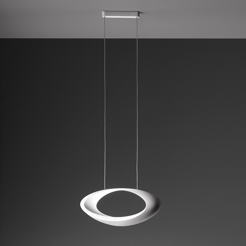 Artemide Cabildo pendant lamp: white sculptural ring-shaped shade, tilted elliptical form, suspended by thin cables from ceiling canopy