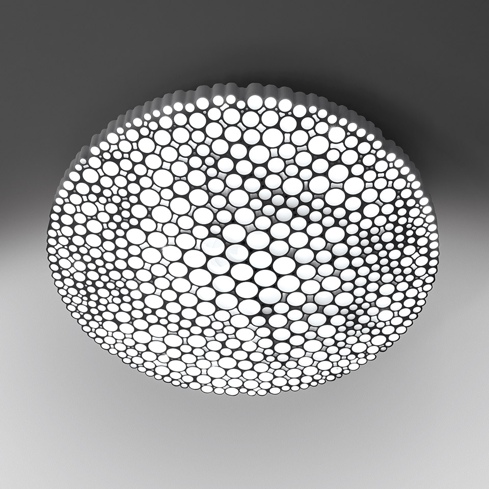 Artemide Calipso ceiling lamp, round white diffuser with circular bubble pattern cutouts emitting soft, uniform light