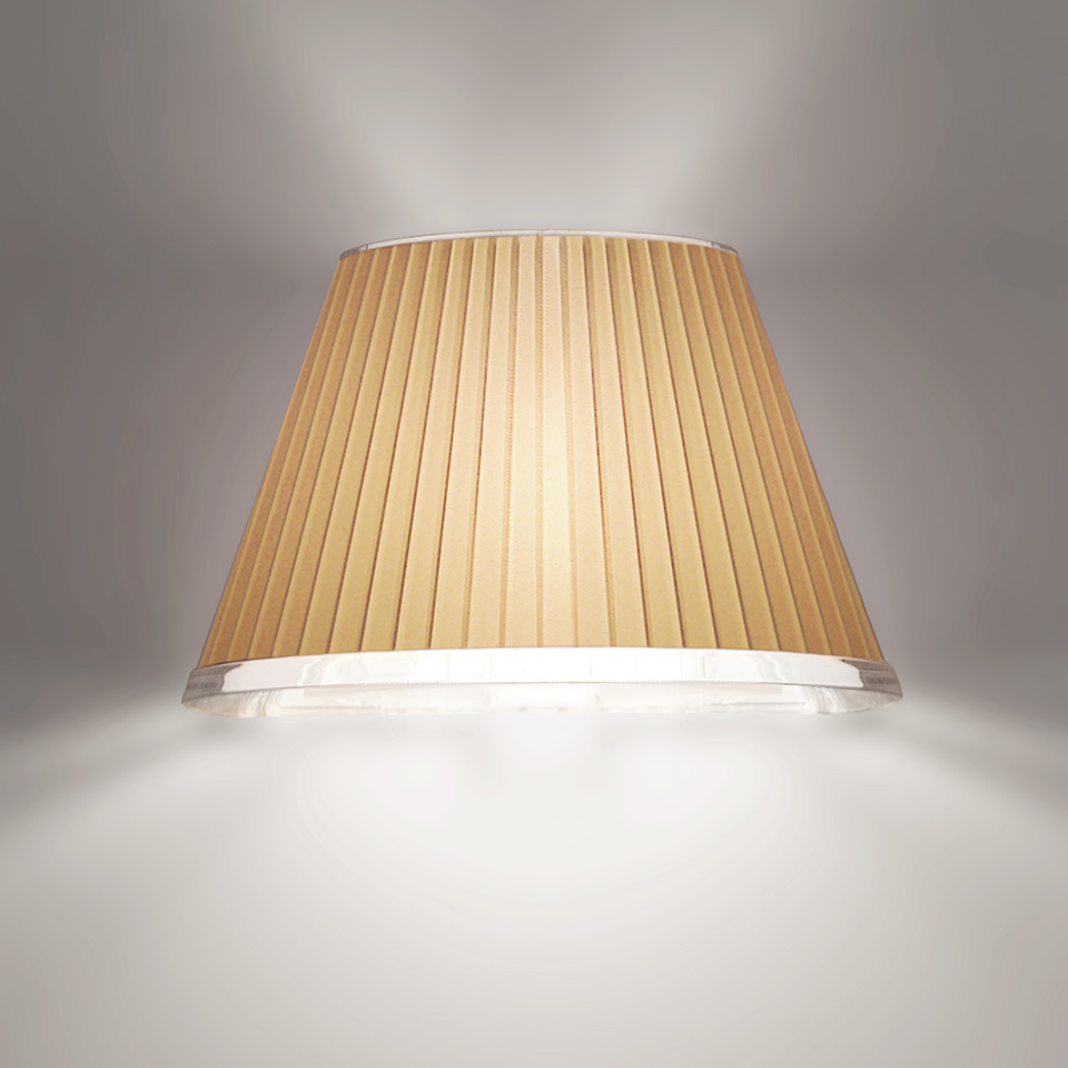 Artemide wall lamp with pleated beige fabric shade, emitting warm upward and downward light against a grey wall