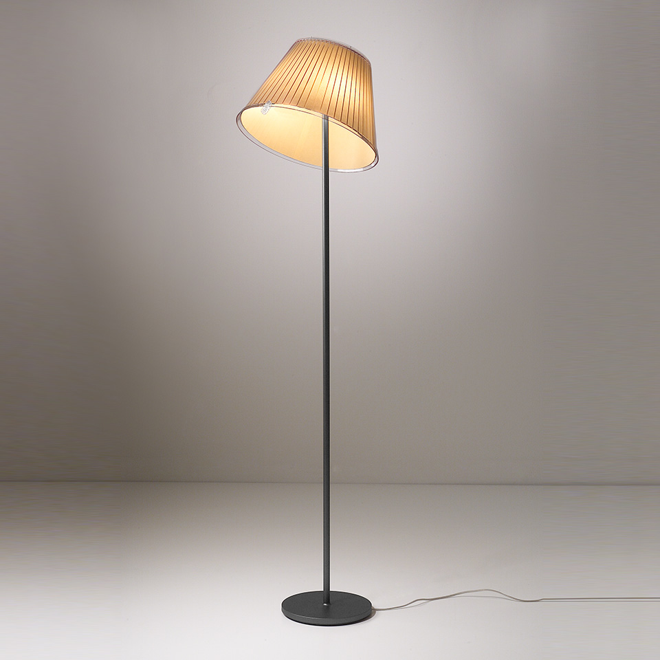 Artemide Choose floor lamp with pleated fabric shade tilted at an angle on a slim dark metal stem and round base