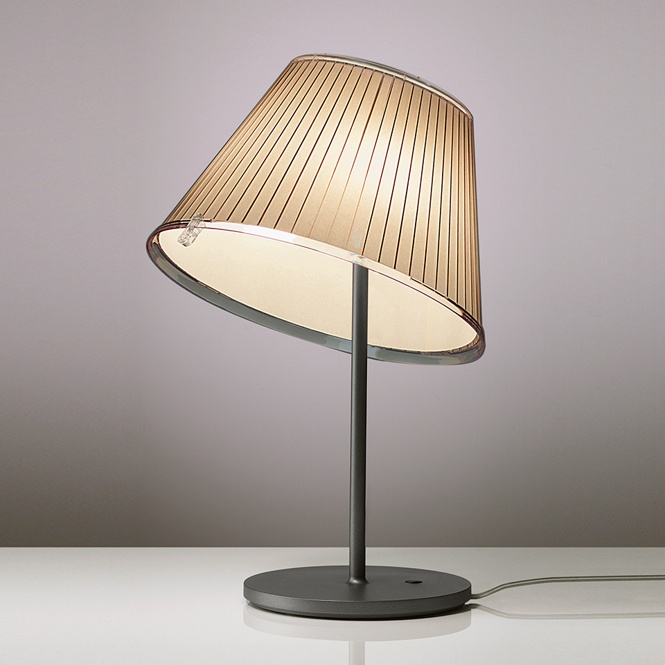 Artemide Choose table lamp with tilted pleated fabric shade, transparent rim, and dark metal stem and base
