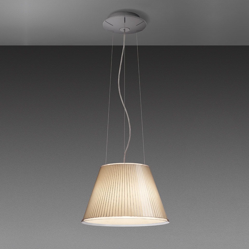 Artemide pendant lamp with tapered pleated fabric shade in warm beige, suspended by thin cables from a circular ceiling canopy