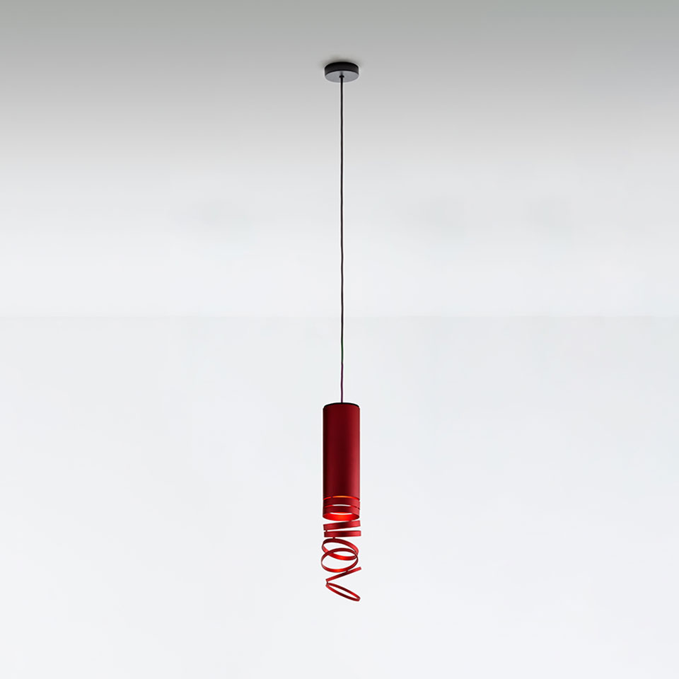 Artemide Decomposé Light pendant lamp in red, featuring a cylindrical body with a spiraling coiled element at the bottom, suspended by a black cord - 2