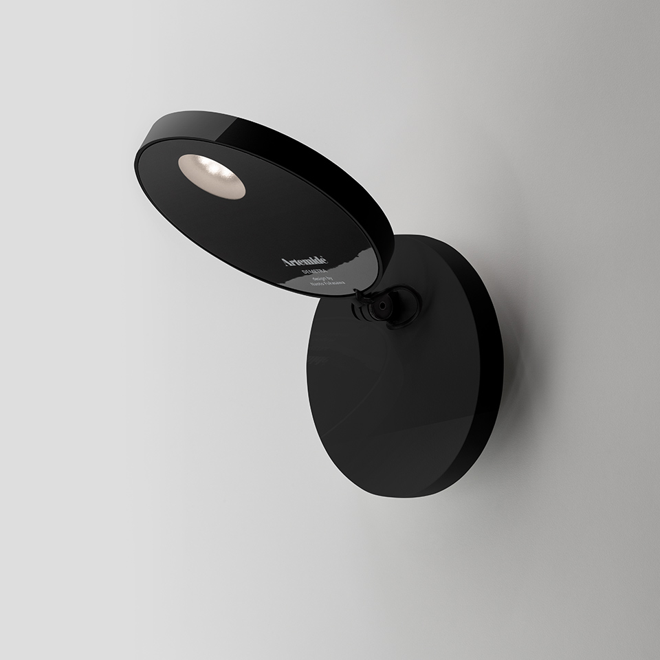 Artemide Demetra Faretto black wall spotlight with adjustable oval head and integrated LED, mounted on circular base