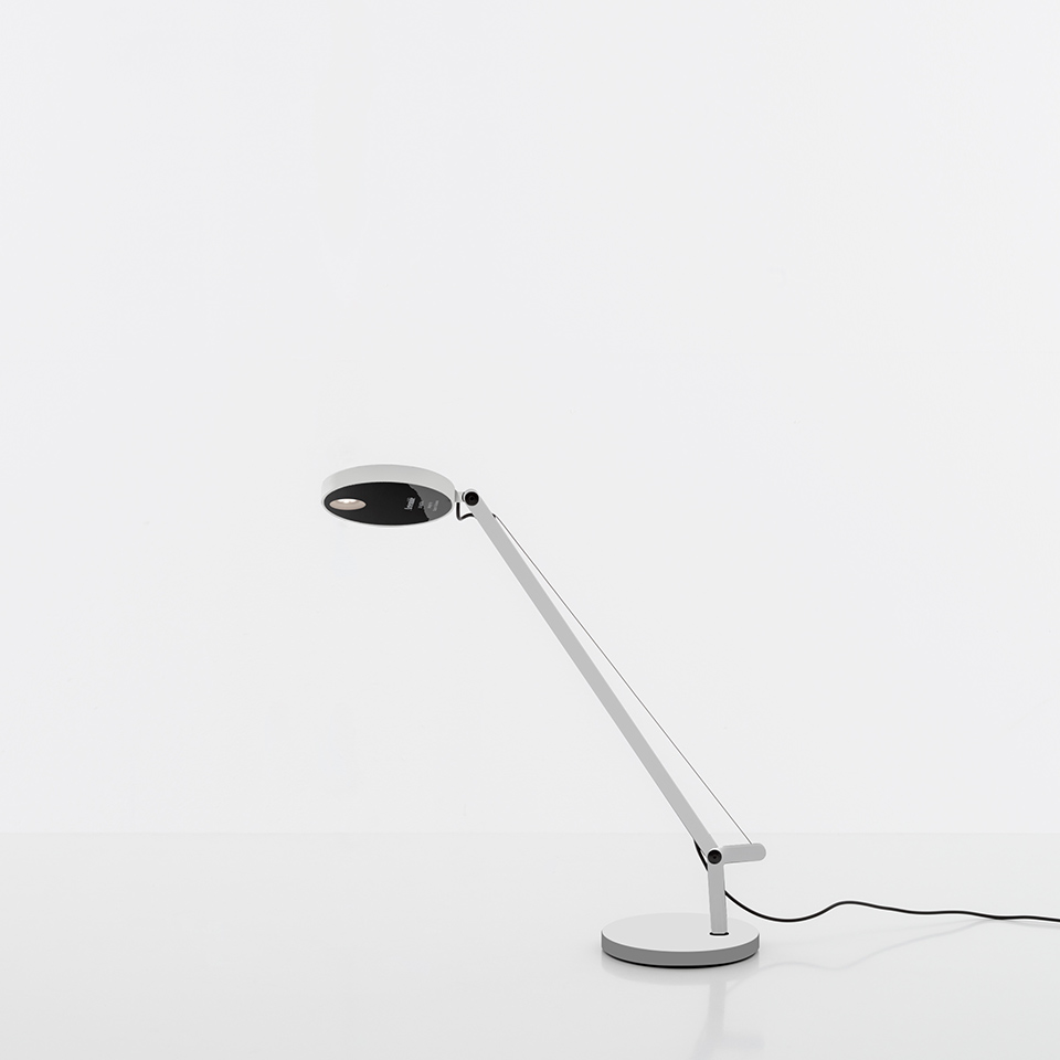 Artemide Demetra Micro table lamp in white with adjustable arm, circular black reflector head, and round base