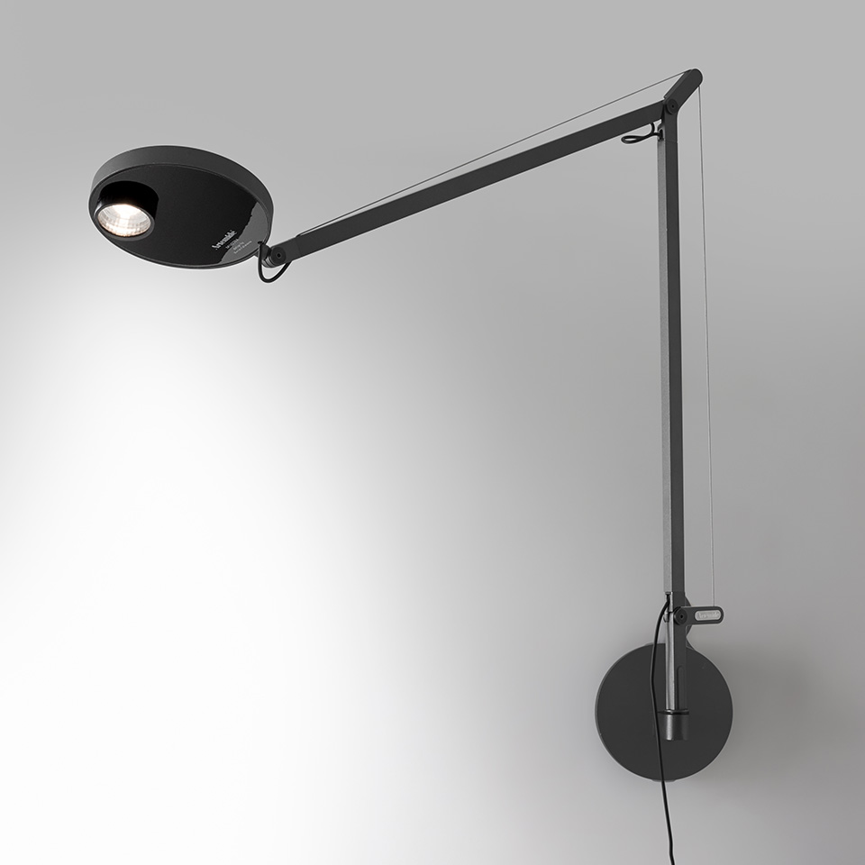 Artemide Demetra Professional wall lamp in black, featuring an adjustable articulated arm with tension cable and circular LED head