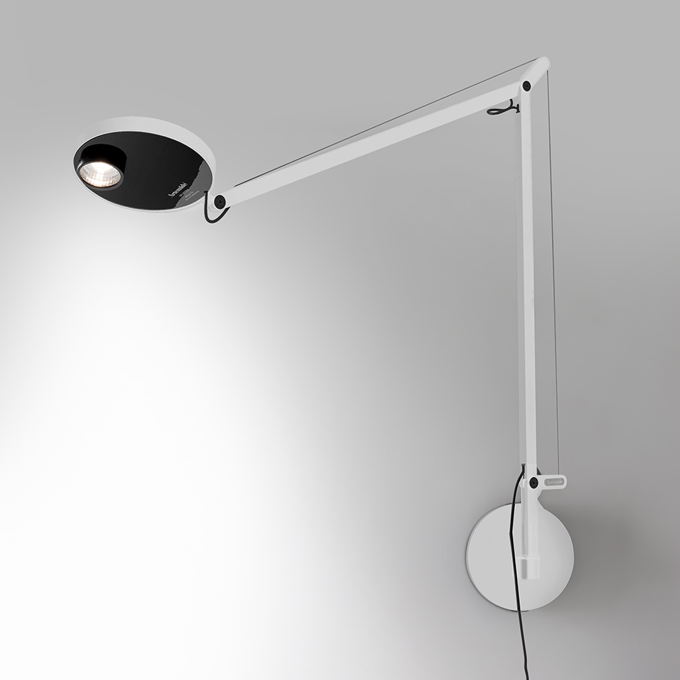 Artemide Demetra Professional wall lamp: white articulated arm with black oval LED head, mounted on circular wall bracket