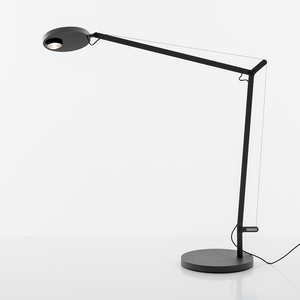 Artemide Demetra Professional desk lamp in black, featuring articulated arm, circular LED head, and round base
