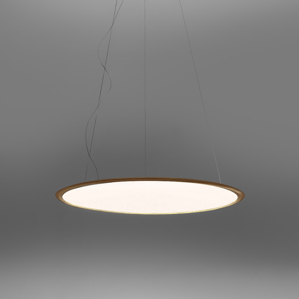 Artemide Discovery pendant lamp: large circular disc with white diffuser and warm gold rim, suspended by thin cables