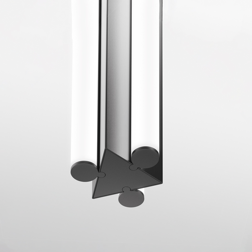Close-up of Artemide Dreispitz lamp base: dark triangular connector joining three cylindrical frosted glass tubes with circular end caps