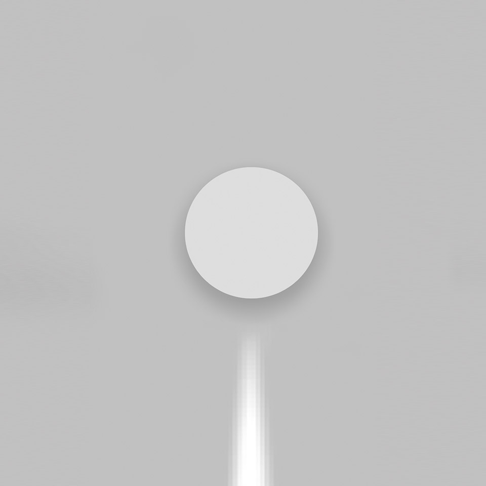 Artemide Effetto wall light: circular white diffuser mounted on wall emitting a focused downward beam of light