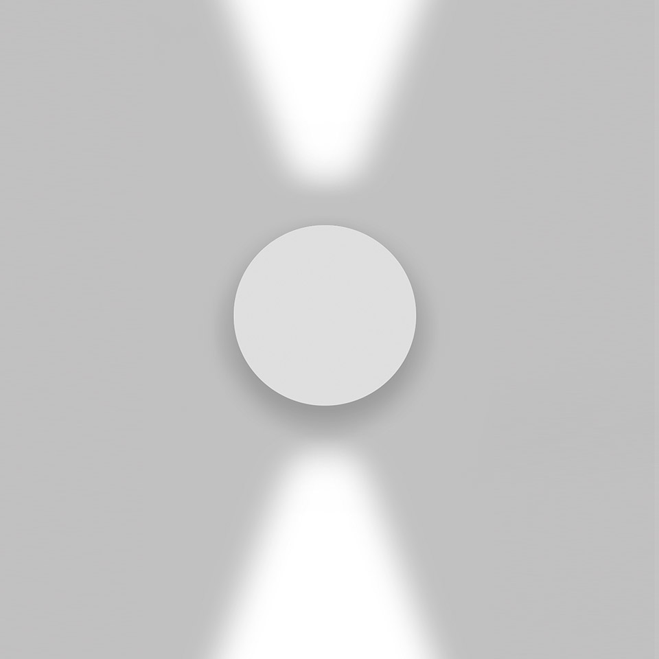 Artemide Effetto wall light: circular white fixture emitting two focused beams upward and downward on a grey wall