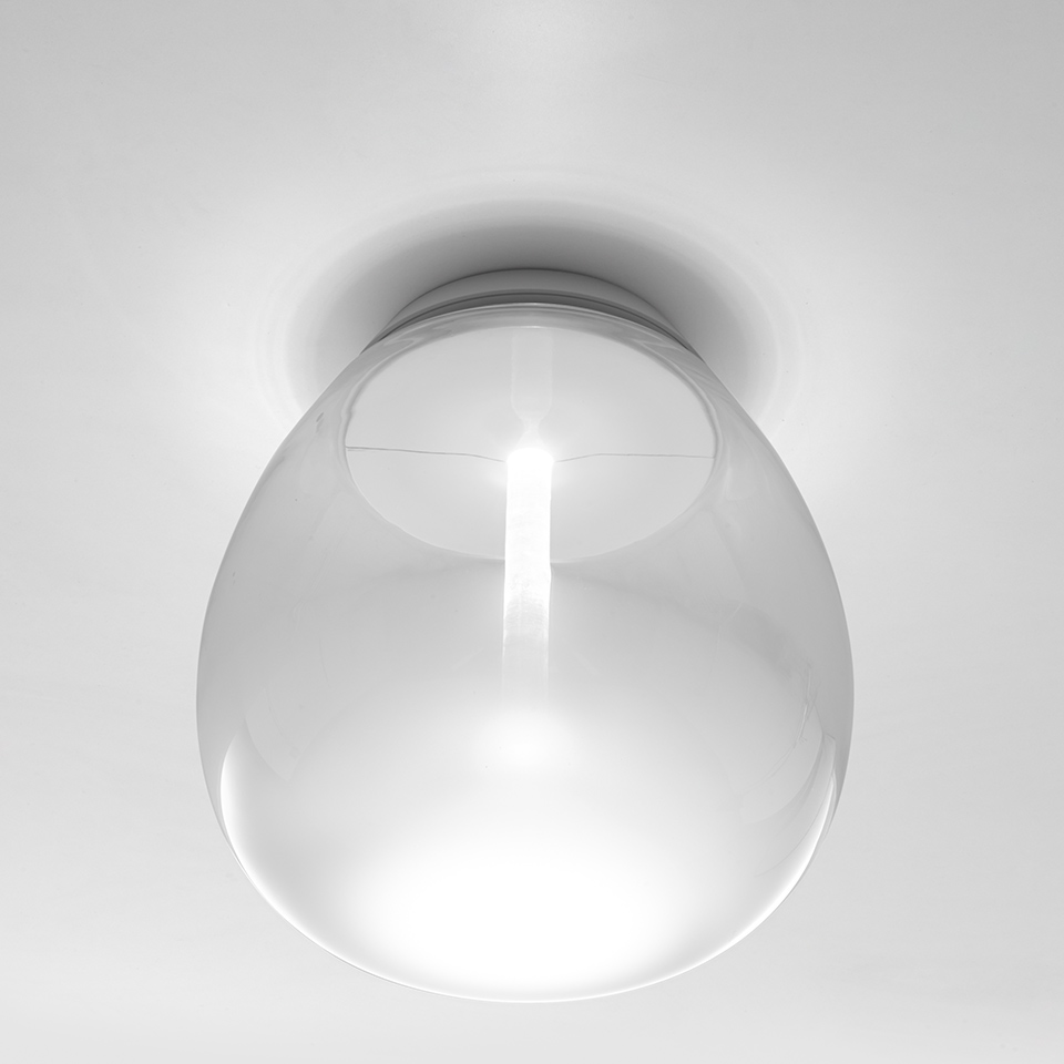 Artemide Empatia wall/ceiling lamp: transparent blown glass dome diffuser mounted flush on white ceiling, emitting soft centered light