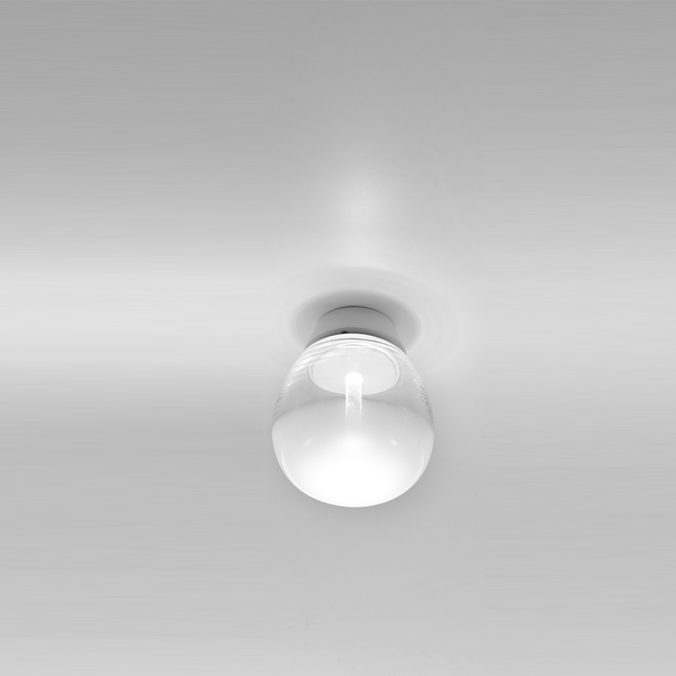 Artemide Empatia wall/ceiling lamp: compact white spherical glass diffuser mounted flush on ceiling, emitting soft diffused light