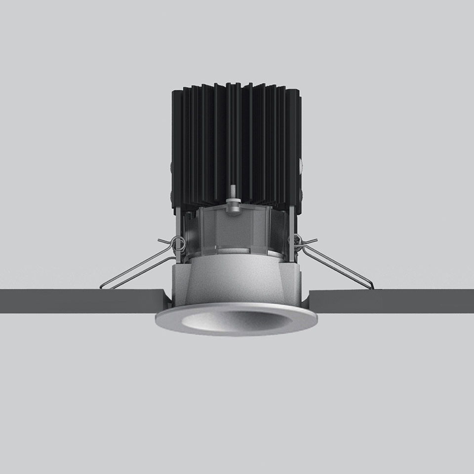 Artemide Everything 55 recessed LED downlight in silver, with black finned heat sink and spring-clip ceiling mounting system