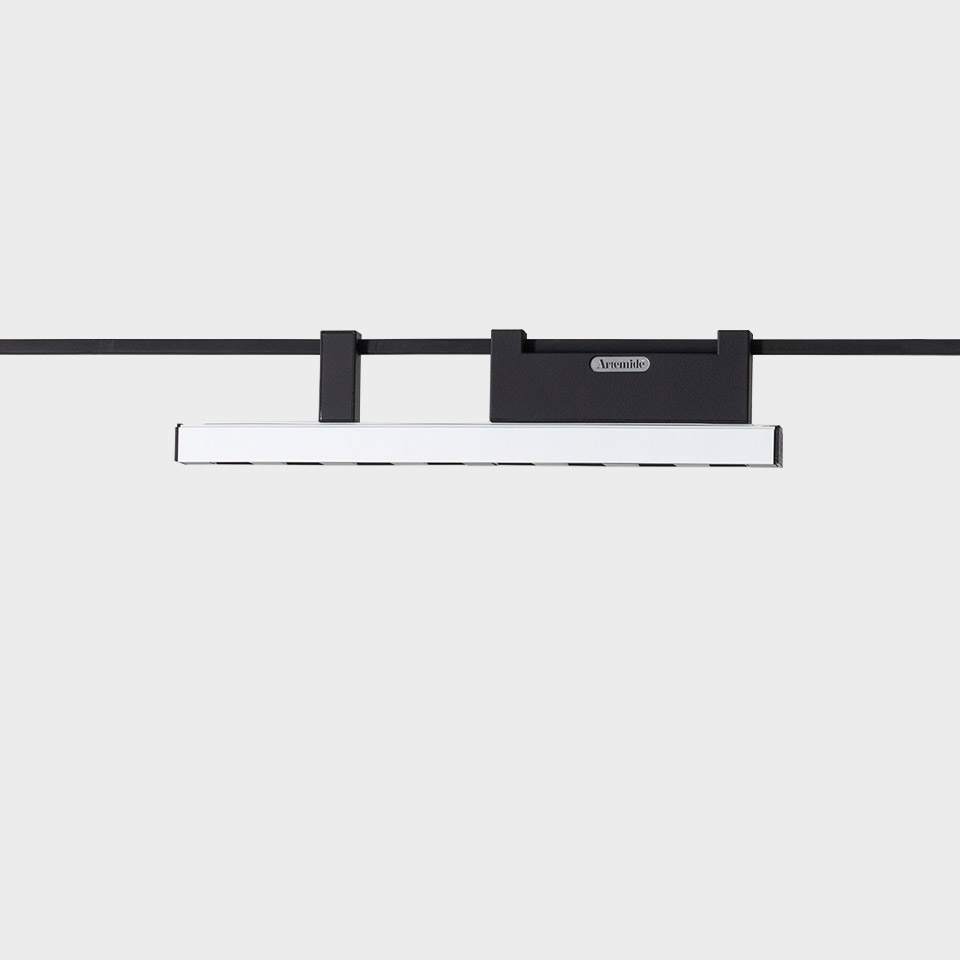 Artemide Funivia LED track light: slim white linear bar suspended from black magnetic rail mount