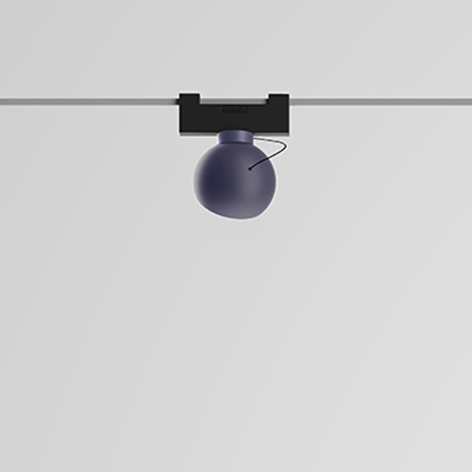 Artemide Funivia track spotlight with matte blue spherical diffuser mounted on black magnetic rail system