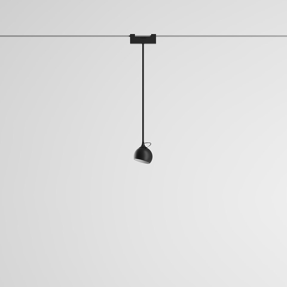 Artemide Funivia pendant lamp: black dome-shaped shade suspended on a thin black cable from a ceiling track mount