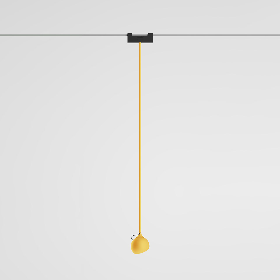 Artemide Funivia pendant lamp: yellow spherical shade hanging from a long yellow cable on a dark magnetic track ceiling mount